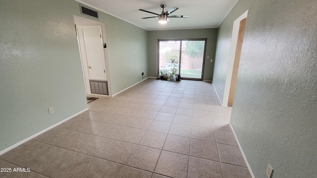 650 N 65th Way, Mesa, AZ 85205 - spare room featuring a textured wall, ceiling fan, light tile patterned flooring, baseboards, and crown molding