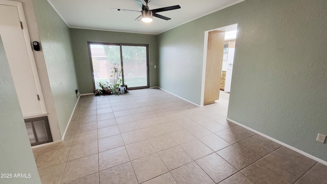650 N 65th Way, Mesa, AZ 85205 - empty room with a textured wall, a ceiling fan, light tile patterned floors, crown molding, and baseboards