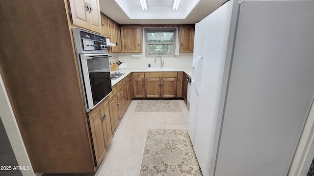 650 N 65th Way, Mesa, AZ 85205 - kitchen with white refrigerator with ice dispenser, wall oven, a sink, light tile patterned floors, and a tray ceiling