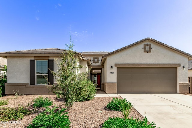 view of front of home with driveway, a garage, and stucco siding