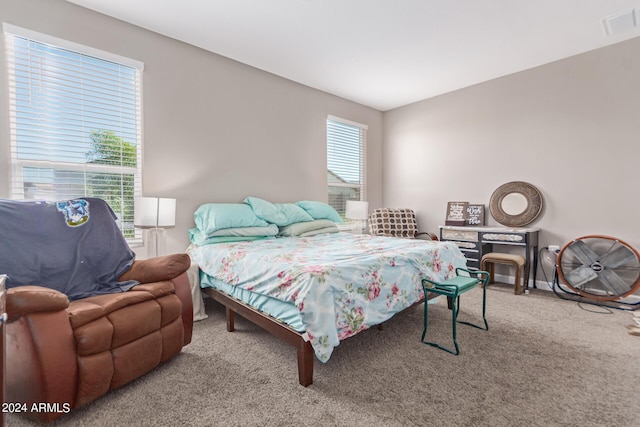 carpeted bedroom with baseboards and visible vents