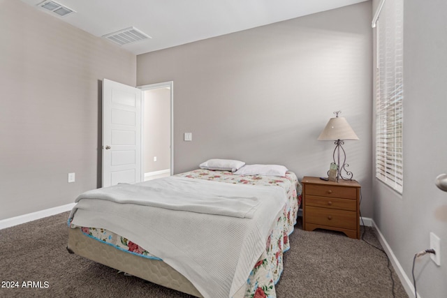 bedroom with baseboards, carpet flooring, and visible vents