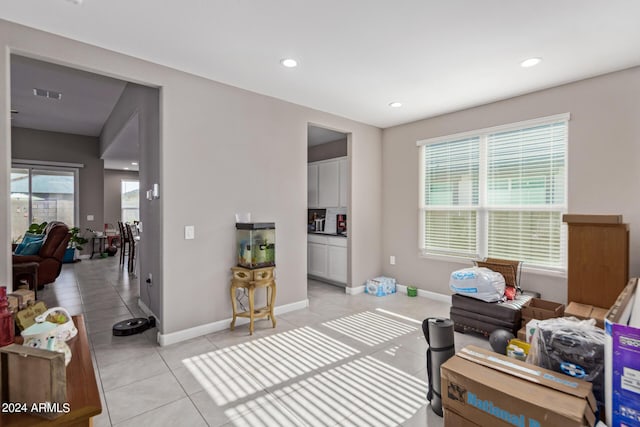 interior space featuring recessed lighting, baseboards, multiple windows, and visible vents