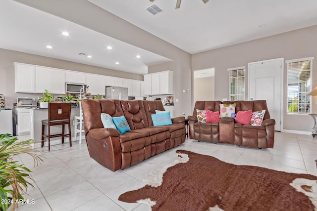 living room featuring light tile patterned flooring, baseboards, visible vents, and recessed lighting