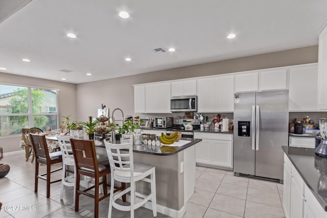 kitchen with recessed lighting, dark countertops, appliances with stainless steel finishes, and visible vents