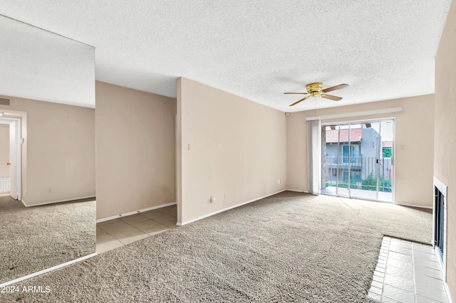 unfurnished living room with a textured ceiling, light carpet, and ceiling fan