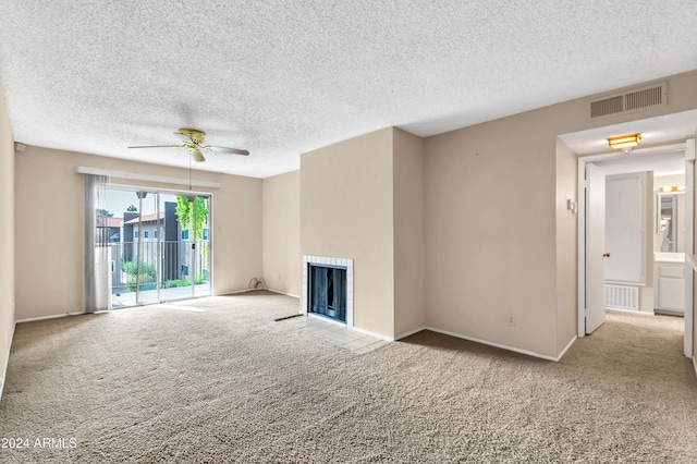 unfurnished living room with ceiling fan, a textured ceiling, and light carpet