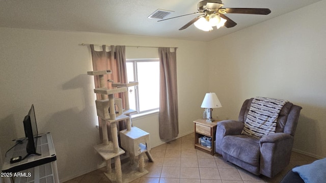 sitting room with ceiling fan and light tile patterned flooring