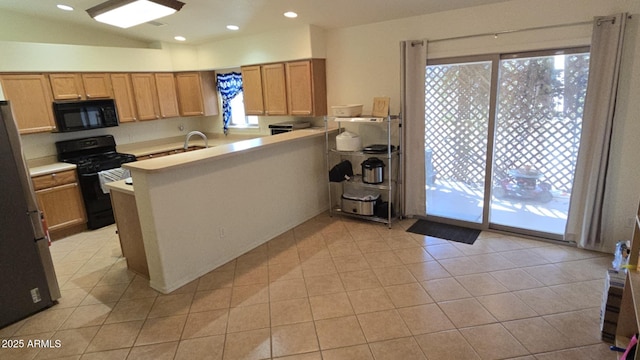 kitchen with kitchen peninsula, light tile patterned floors, lofted ceiling, and black appliances