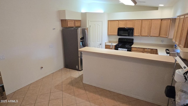 kitchen featuring light tile patterned flooring, sink, and black appliances