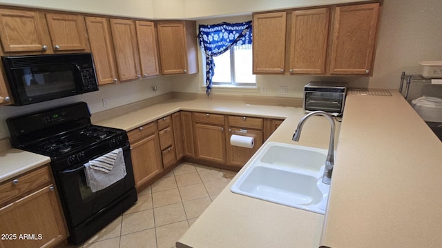 kitchen featuring light tile patterned floors, sink, and black appliances