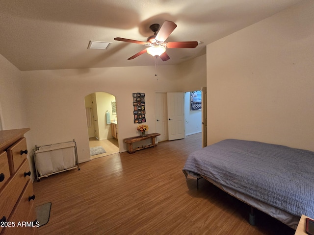 bedroom featuring ensuite bath, ceiling fan, and hardwood / wood-style flooring