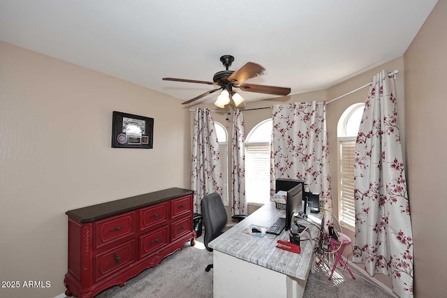 office area with ceiling fan and light carpet