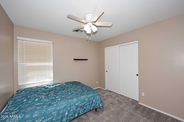carpeted bedroom featuring a closet, ceiling fan, and visible vents