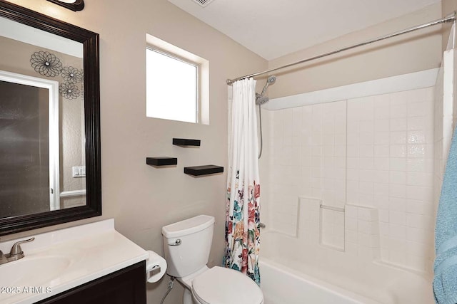 bathroom with toilet, vanity, and shower / tub combo