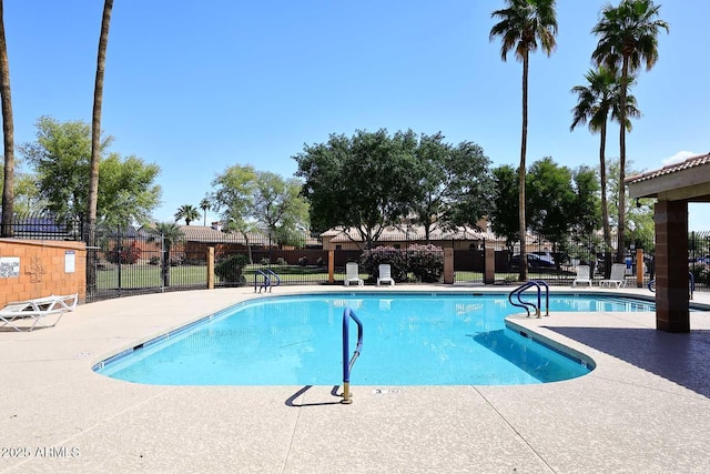 pool with fence and a patio