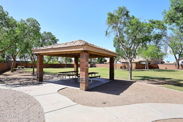 view of home's community with a fenced backyard, a gazebo, a yard, and a patio area