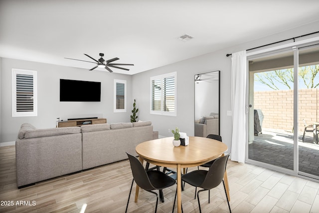 dining room with ceiling fan and light wood-type flooring