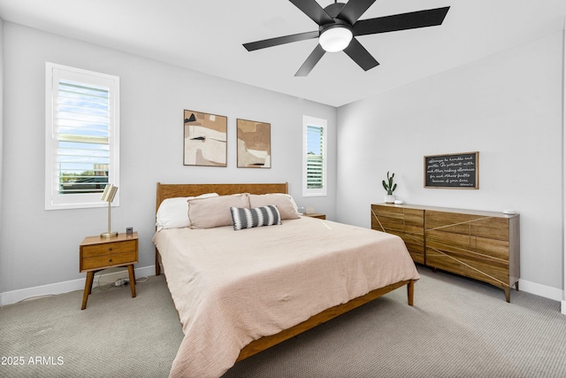 bedroom featuring light colored carpet and ceiling fan