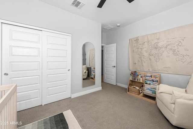 living area with carpet floors and ceiling fan