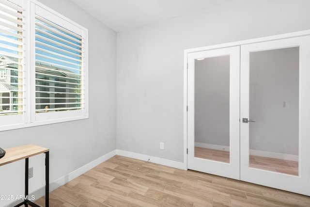 interior space featuring french doors and light wood-type flooring