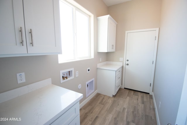 clothes washing area featuring hookup for a washing machine, cabinet space, light wood-style floors, electric dryer hookup, and baseboards