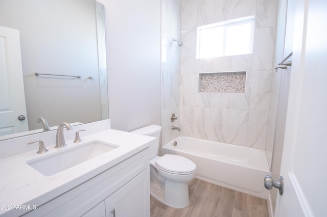 full bathroom featuring shower / bathtub combination, vanity, wood finished floors, and toilet