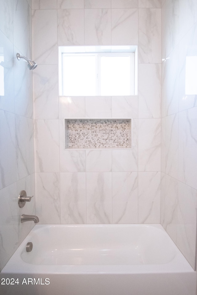 bathroom with washtub / shower combination