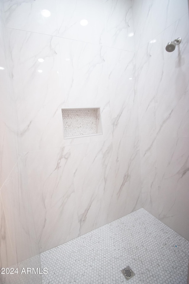 room details featuring a marble finish shower