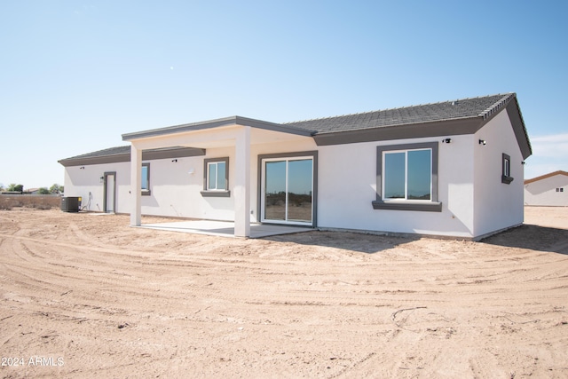 back of house featuring a patio area, stucco siding, and central air condition unit