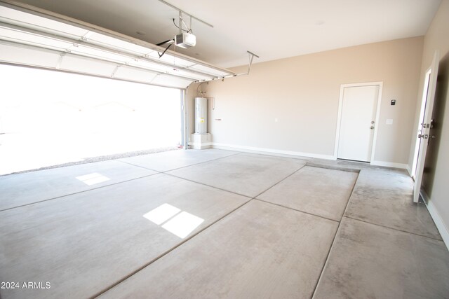 garage with a garage door opener, water heater, and baseboards