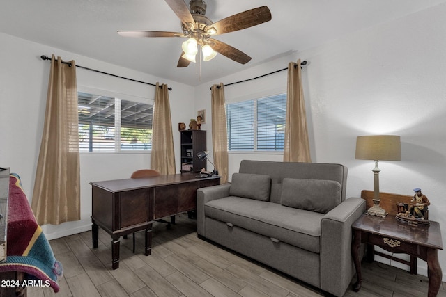 office space with light hardwood / wood-style floors and ceiling fan