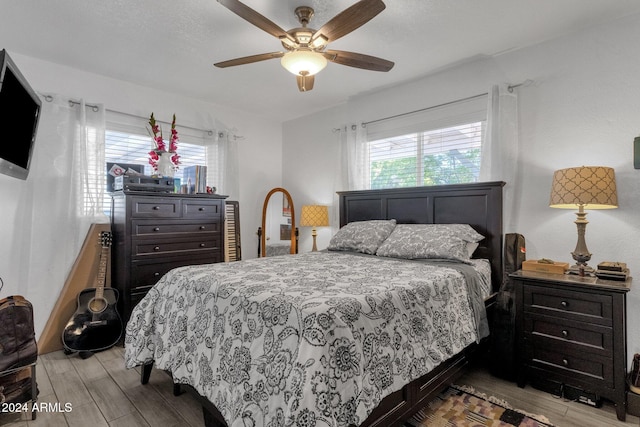 bedroom featuring light hardwood / wood-style flooring and ceiling fan