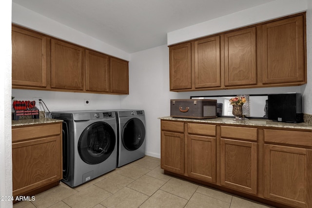 laundry area featuring washer and dryer and light tile patterned floors