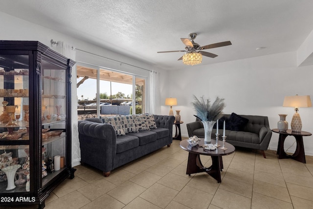 tiled living room with ceiling fan and a textured ceiling