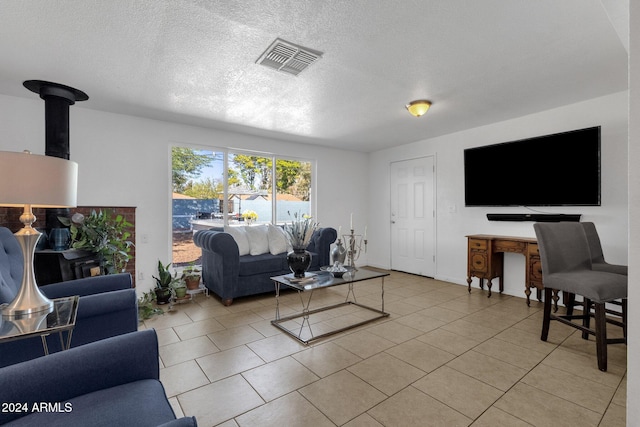 living room featuring light tile patterned floors and a textured ceiling