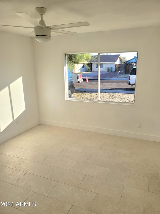 spare room with light tile patterned floors and ceiling fan