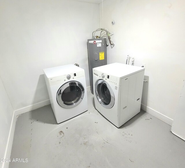 washroom with electric water heater and washing machine and clothes dryer