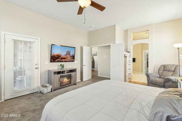 bedroom featuring access to outside, light colored carpet, and ceiling fan