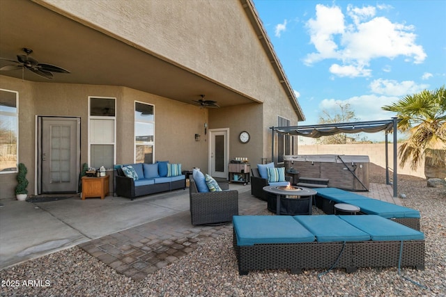 view of patio featuring a hot tub and an outdoor living space with a fire pit