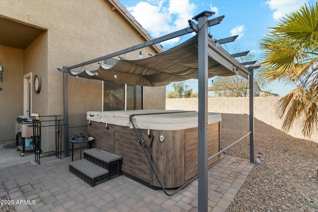 view of patio / terrace with a hot tub