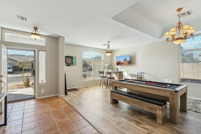 playroom with billiards, hardwood / wood-style flooring, and a notable chandelier