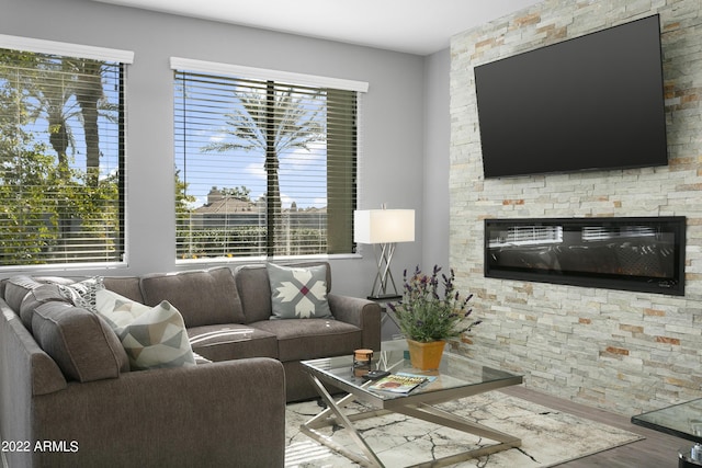 7700 E Gainey Ranch Rd Unit 206, Scottsdale, AZ 85258 - living area featuring wood finished floors and a stone fireplace
