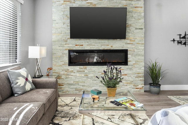 7700 E Gainey Ranch Rd Unit 206, Scottsdale, AZ 85258 - living area featuring wood finished floors, a fireplace, and baseboards
