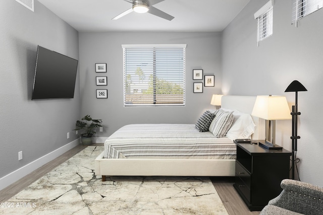 7700 E Gainey Ranch Rd Unit 206, Scottsdale, AZ 85258 - bedroom featuring wood finished floors, multiple windows, and baseboards