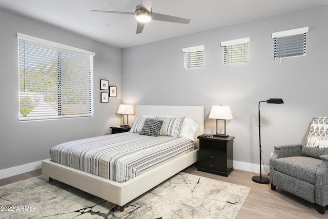 7700 E Gainey Ranch Rd Unit 206, Scottsdale, AZ 85258 - bedroom with baseboards, wood finished floors, and a ceiling fan