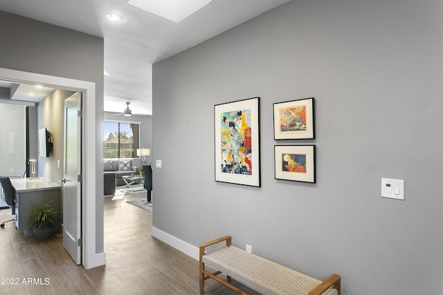 7700 E Gainey Ranch Rd Unit 206, Scottsdale, AZ 85258 - hallway with wood finished floors, baseboards, recessed lighting, and a skylight