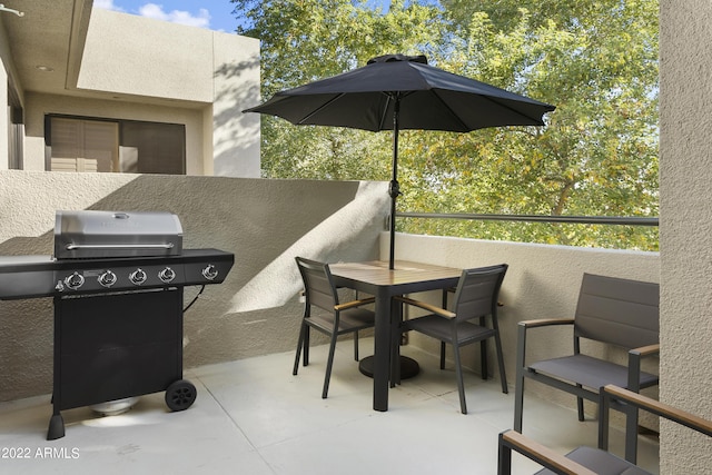 7700 E Gainey Ranch Rd Unit 206, Scottsdale, AZ 85258 - view of patio featuring a grill, outdoor dining area, and a balcony