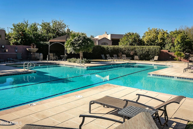 view of swimming pool featuring a patio