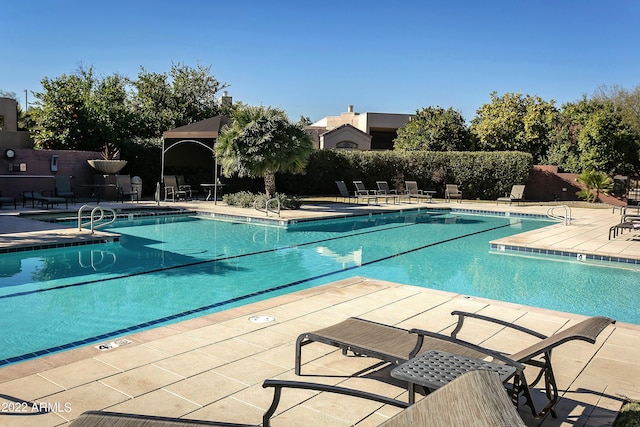 7700 E Gainey Ranch Rd Unit 206, Scottsdale, AZ 85258 - community pool featuring a patio